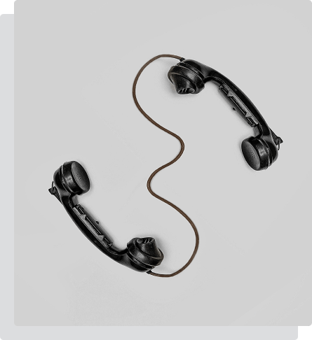 Two phones connected to each other by a wire to indicate communication